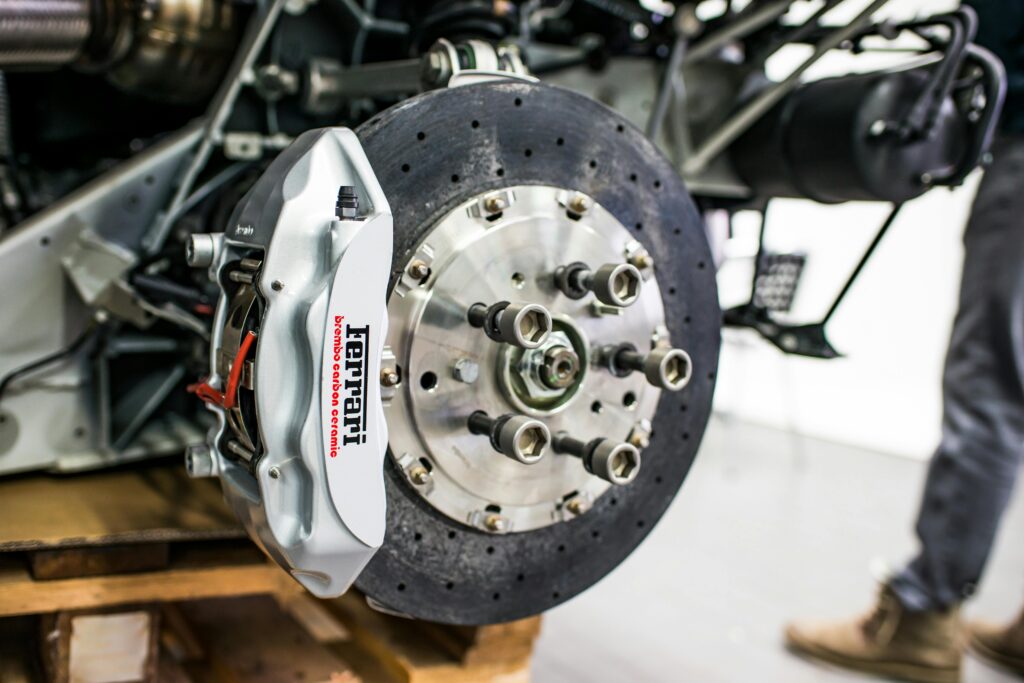 Detailed view of disc brake and caliper on a high-performance car, emphasizing precision and technology.